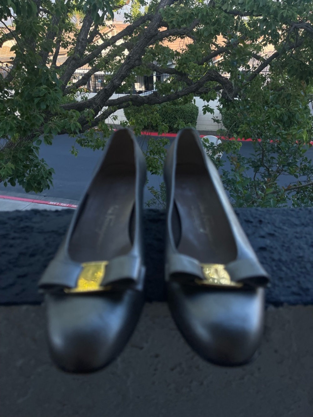 Salvatore Ferragamo Black Leather Bow Pumps with Gold Logo Plaque